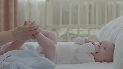 Loving touch of elder hand with baby boy feet, tender interaction with child, nurture connection. Infant held by grandmother hand, bond moment, Gentle touch between generation, emotional family moment - Powered by Adobe