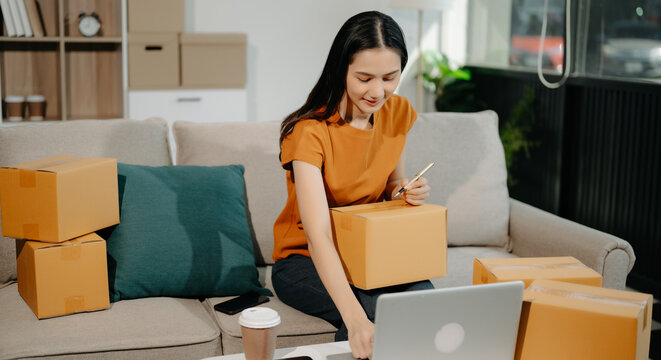 Startup small business SME, Entrepreneur owner woman using smartphone or tablet taking receive and checking online purchase shopping order