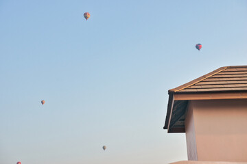 Fototapeta na wymiar 19022024 Colorful hot air balloons fly over the Vang vieng city, Laos in Asia. This was during sunrise on a clear hot day during dry season.
