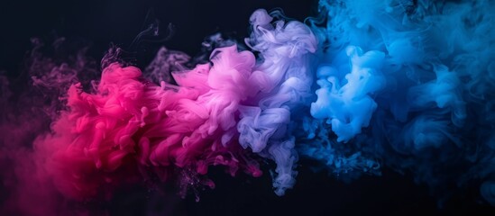 Fototapeta premium Vibrant and colorful swirling smoke over dark black background for creative design projects