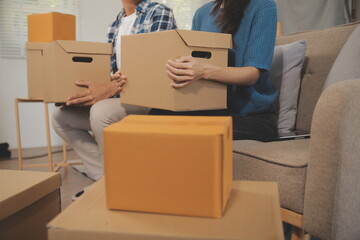 Two Asian blogger showing clothes in front of the camera to recording vlog video live streaming at her shop. Online Shopping Cart notion. on sofa at home