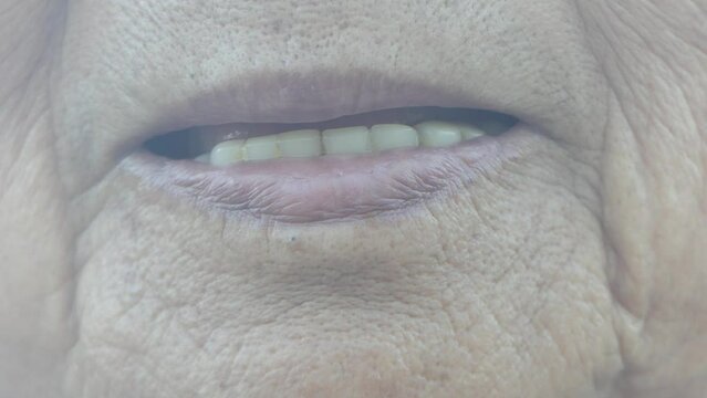 shot of toothless female smile mouth of senior elderly woman