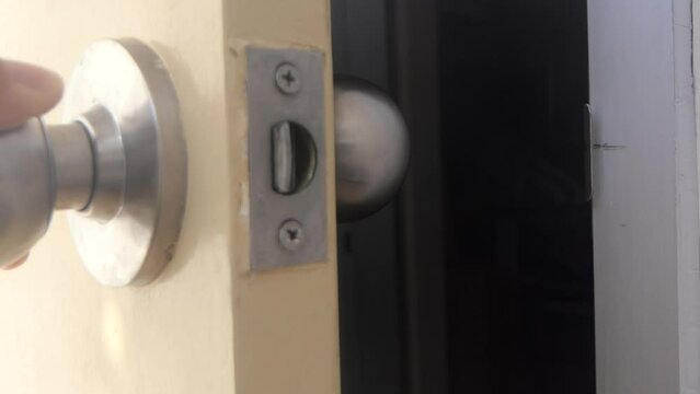 man opening wooden door