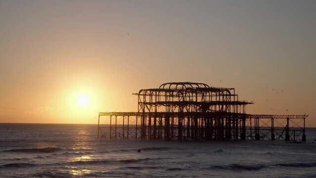 West Pier, Brighton, Silhouetted at Sunset with Birds Flying Around