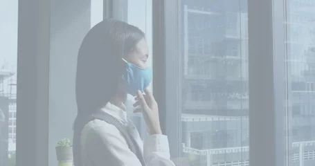 Fotobehang Aziatische plekken Image of financial data processing over asian businesswoman thinking with face mask in office