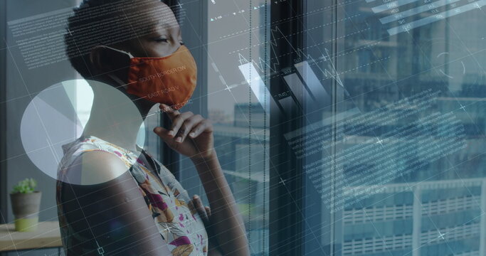 Image of financial data processing over businesswoman with face mask thinking in office