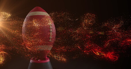 Image of glowing orange particles moving over rugby ball