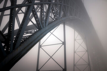 Iron frame of Dom Luis bridge in thick fog, Porto, Portugal.