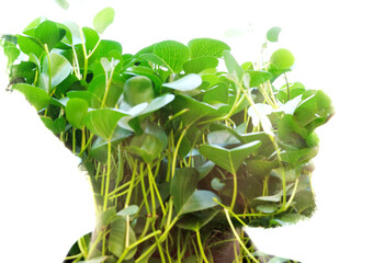 A green and vibrant, disappearing half-profile portrait in double exposure - 740500086