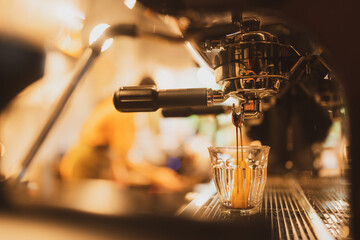 Professional brewing, coffee bar details. Espresso coffee pouring from espresso machine. Barista...