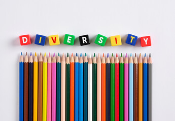 Diversity concept in education and schooling. The word diversity on colorful cubes with crayons.
