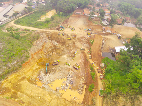 Aerial view of a group of trucks in a mining area in Cikancung City, West Java Province, Indonesia. Landscape view of trucks waiting in line. Shot from a drone flying 200 meters high.