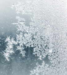 Frosty patterns on the window glass as a background