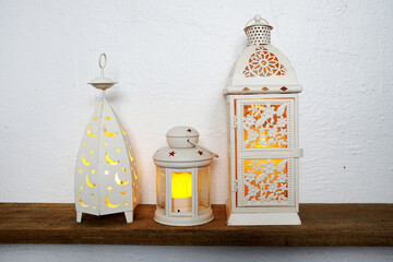 White lantern with LED candle light Home decoration accessories on wooden shelves