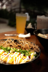 Japanese ramen, chopsticks, egg in bowl, traditional cuisine served, noodles, meat in close-up view, hot soup filled with toppings,