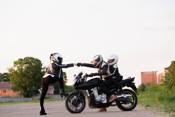 Fototapeta na wymiar Portrait of a group of bikers on a motorcycle
