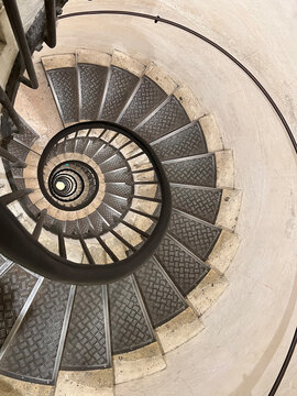 Never ending winding staircase with black railing