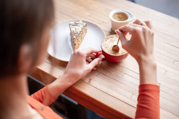 Cropped Shot of an Unrecognizable Woman Enjoying Coffee With Cake