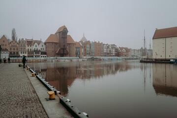 Foggy port in the old town and fisherman in Gdansk Poland