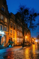 Evening street in the old town in Gdansk Poland, wet snow