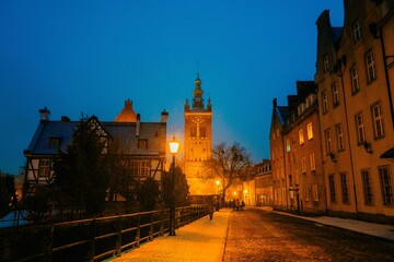Fototapeta na wymiar Evening street in the old town in Gdansk Poland, wet snow