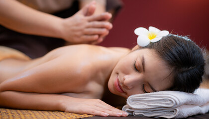 Obraz na płótnie Canvas Young Beautiful Asian Woman relax massage in spa salon
