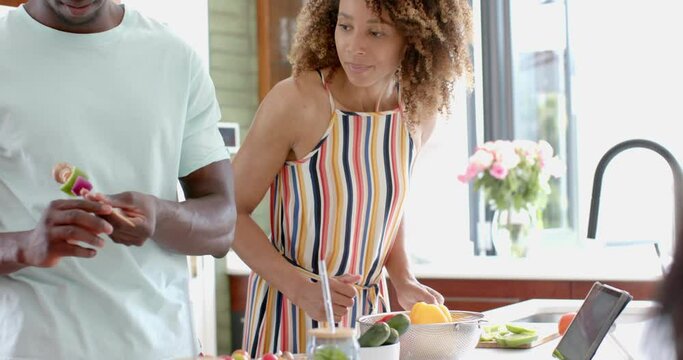 Biracial couple enjoys cooking together at home