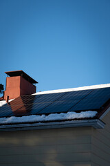 solar panels on top of home roof with snow