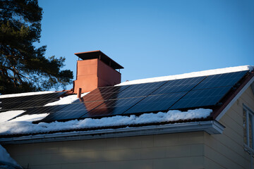 solar panels on top of home roof with snow
