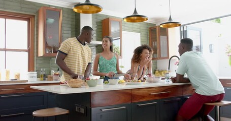 Diverse group enjoys a conversation in a modern home kitchen