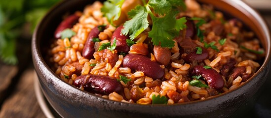 A traditional dish of rice and beans served in a bowl on a wooden table, showcasing a staple food recipe rich in ingredients and flavors