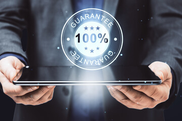 Businessman presenting a digital guarantee badge hologram on a tablet, secure service concept
