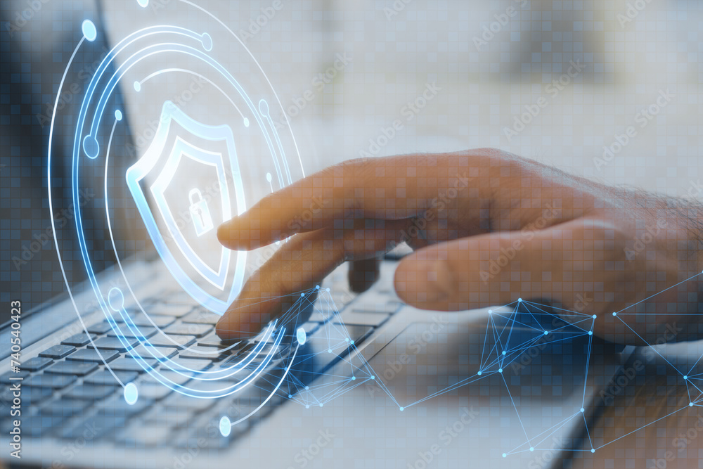Poster close up of male hand using laptop keyboard with creative round safety hologram with polygonal mesh 