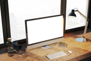 Creative designer desktop with empty white computer monitor, lamp, supplies and other items. Window with city view in the background. Mock up, 3D Rendering.