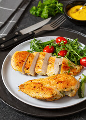 fried chicken breasts with green salad on plate