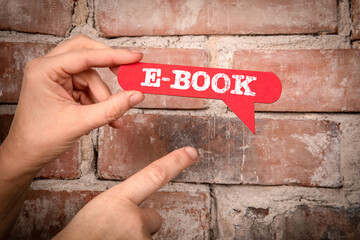E-Book. Red speech bubble with text on a red brick background