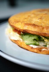 Spanish potato omelette, vegetable omelette on white plate and black background