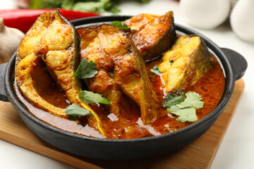 Tasty fish curry on table, closeup. Indian cuisine