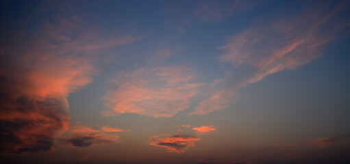 Sunset sky with orange clouds. Nature background.