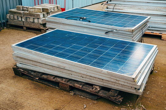 Old obsolete solar panels in factory yard
