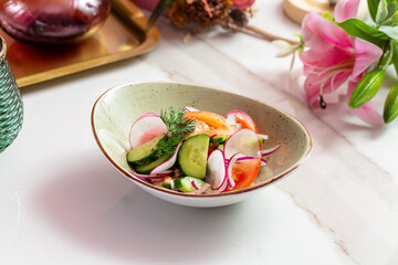 Fresh vegetable salad: radish, cucumber, tomato. Lunch.