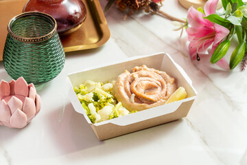 Salmon with broccoli. Diet food In disposable paper eco-friendly packaging.