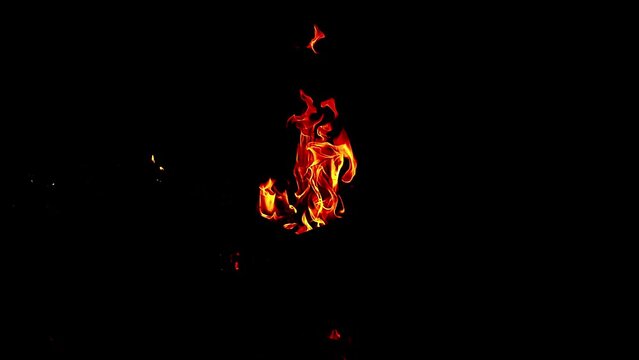 Small torch fire - small camp fire - fire and flames - isolated on black background - 4K Video