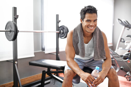 Happy, man and portrait at gym with water bottle for recovery after exercise and body building. Healthy, fitness or person relax after workout with liquid hydration for benefits to wellness in Mexico