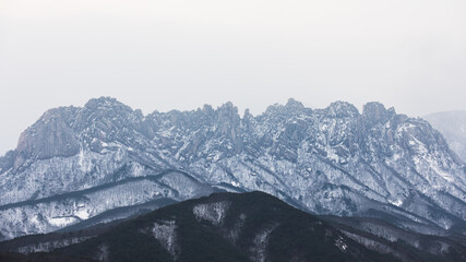Snow-covered Ulsanbawi.  Seoraksan Mountain, Korea. Ulsanbawi is terrain showing signs of...
