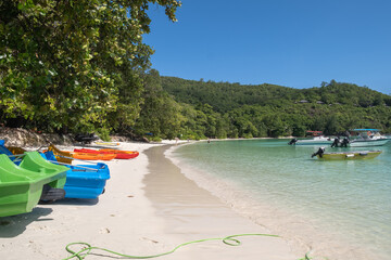 colorful boats on the tropical white sand beach Port Launay beach Seychelles