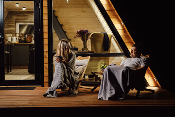 An evening conversation between a friendly couple on the terrace