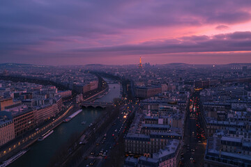 Fototapeta na wymiar Evening drone view of Paris, city lights twinkling