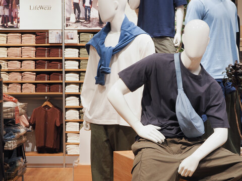 TOKYO, JAPAN - February 16, 2024: Display of clothes and mini round shoulder bags in a Uniqlo store in Tokyo.