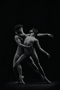 Artistic, talented young man and woman in pointe, ballet dancers performing passionate dance. Monochrome image. Concept of classic art, aesthetics, emotions, ballet dance, talent, love